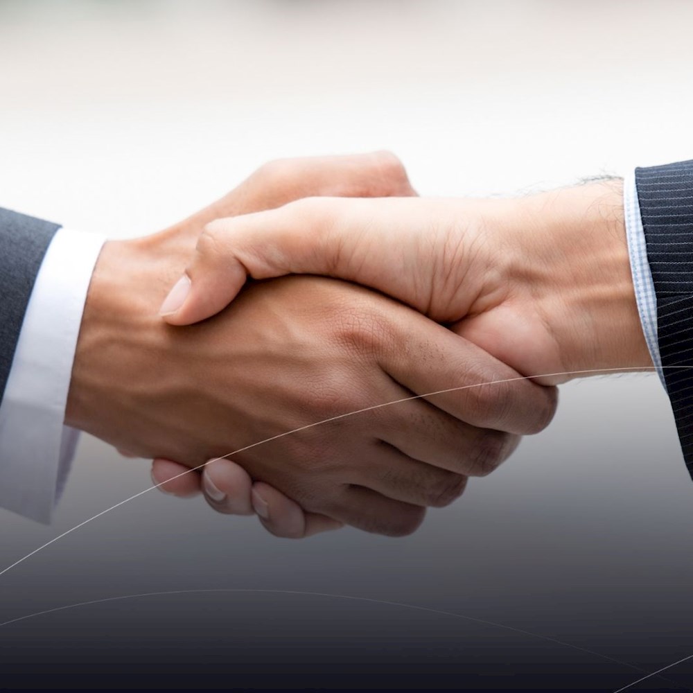 Business handshake symbolizing Mexico’s trade ties, stable politics, and agreements like USMCA for secure logistics.