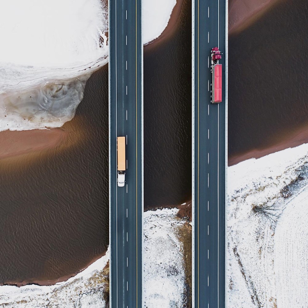 Two trucks crossing snowy highway bridges, symbolizing Mexico’s proximity advantage for faster, cost-effective logistics.