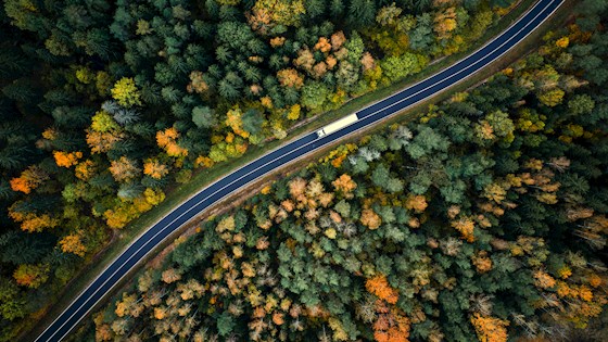 Arial view of heavy truck on a narrow twisting road.